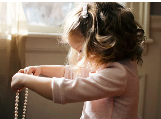 children's fashion child holding jewelry