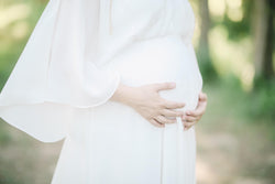 pregnant lady in white dress in summer