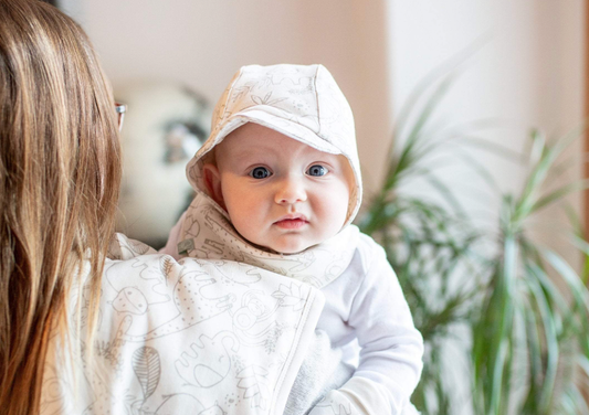 baby with burp cloth laying down