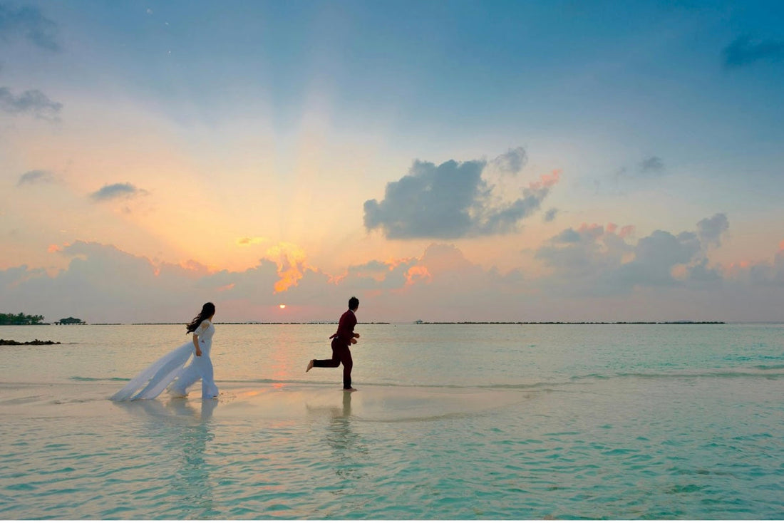 bride and groom running sunset